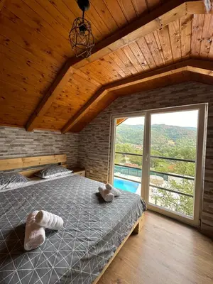 a bedroom with a bed and a large window at Villa Paradise in Banja Luka