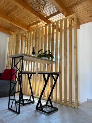 a room with a table in front of a wooden wall at Villa Paradise in Banja Luka