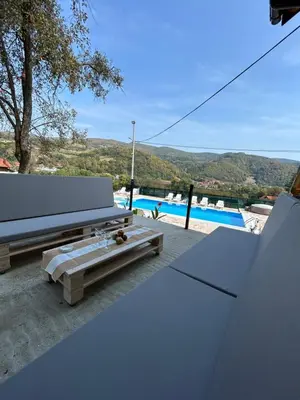 a patio with a bench and a table and a pool at Villa Paradise in Banja Luka