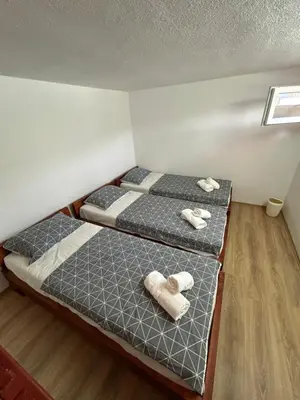 two beds in a room with towels on them at Villa Paradise in Banja Luka