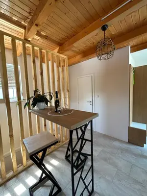 a room with a table with a bottle of wine at Villa Paradise in Banja Luka
