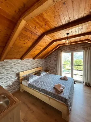 a bedroom with a bed in a brick wall at Villa Paradise in Banja Luka