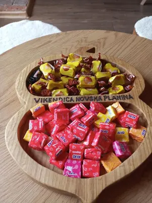 a wooden plate of candy bars on a table at Vikendica Novska planina in Rudice