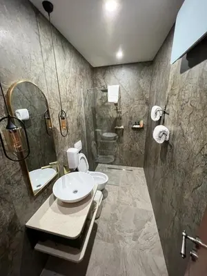 a bathroom with a shower and a toilet and a sink at Soba sa kupaonom i balkonom Aman in Bihać