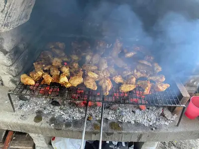 a bunch of chickens are cooking on a grill at Ranc 1001 noc in Mutnik