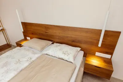 a bed with two pillows on it in a room at Hotel Marina Home in Prijedor