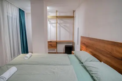 a small bedroom with two beds and a window at Hotel Marina Home in Prijedor