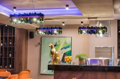 a bar with a statue of a dog on the counter at Hotel Marina Home in Prijedor
