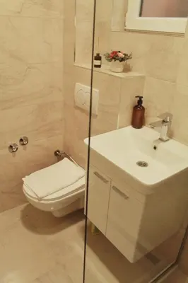 a bathroom with a toilet and a sink at EFESA Apartments in Visoko