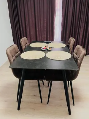 a black table with chairs and a black table with glasses at EFESA Apartments in Visoko