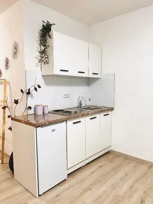 a kitchen with white cabinets and a sink at EFESA Apartments in Visoko