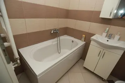 a bathroom with a white tub and a sink at Apartment - Princ in Banja Luka