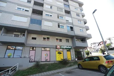 a yellow car parked in front of a building at Apartment - Princ in Banja Luka
