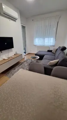 a living room with a couch and a tv at Stan na dan Banjaluka Ada 3 in Rebrovac