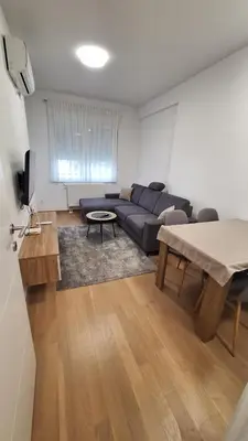 a living room with a couch and a table at Stan na dan Banjaluka Ada 3 in Rebrovac