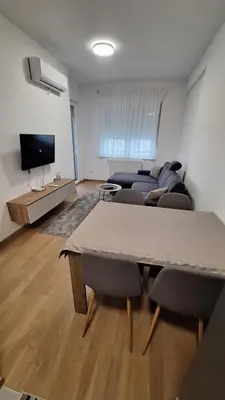 a living room with a couch and a table at Stan na dan Banjaluka Ada 3 in Rebrovac