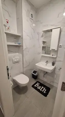 a white bathroom with a toilet and a sink at Stan na dan Banjaluka Ada 3 in Rebrovac