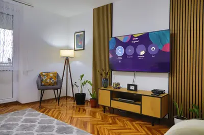 a living room with a flat screen tv on a wall at Apartman Toromanovic in Bihać