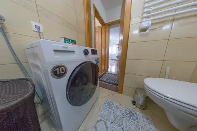 a washing machine in a bathroom next to a toilet at Apartman Toromanovic in Bihać