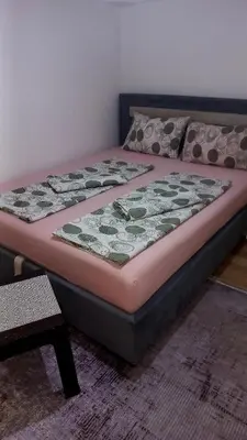 a bed sitting in a room with at Apartman Emina in Visoko