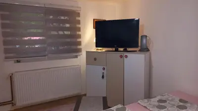 a television on top of a cabinet in a room at Apartman Emina in Visoko