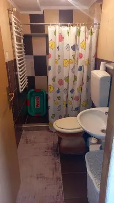 a bathroom with a toilet and a shower curtain at Apartman Emina in Visoko