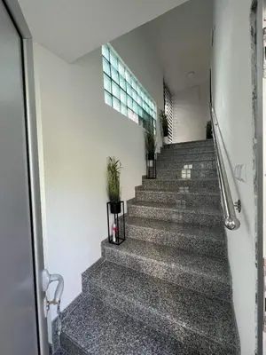 a staircase in a building with potted plants at Apartman City Bihać in Bihać