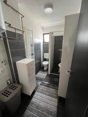 a small bathroom with a toilet and a sink at Apartman City Bihać in Bihać