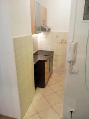 a small kitchen with a sink and a refrigerator at Apartman H&A in Tuzla