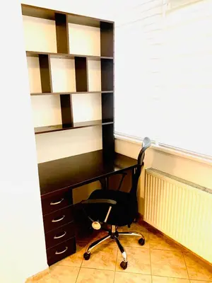 an office with a black desk and a chair at Apartman H&A in Tuzla