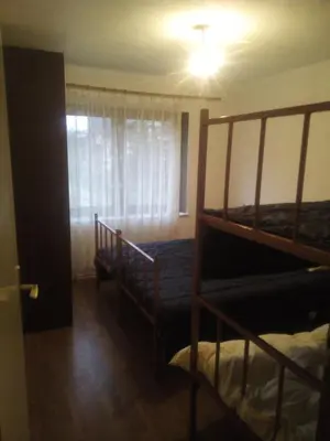 a bedroom with two bunk beds and a window at apartman SM IK 2 in Šujica