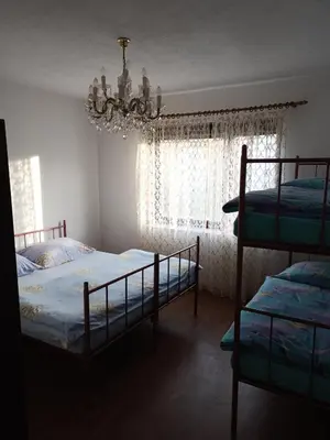 a bedroom with two bunk beds and a chandelier at apartman SM IK 2 in Šujica
