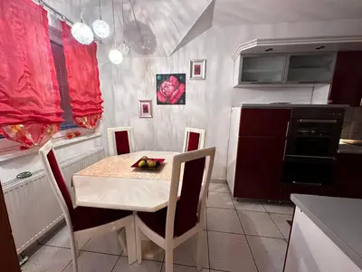 a kitchen with a table and a table and chairs at Srce Cazina in Cazin