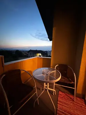 a table and chairs on a balcony with a view at Srce Cazina in Cazin