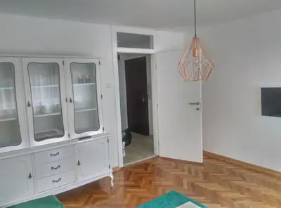 a room with a white cabinet and a hallway at Apartman iza Boske in Banja Luka