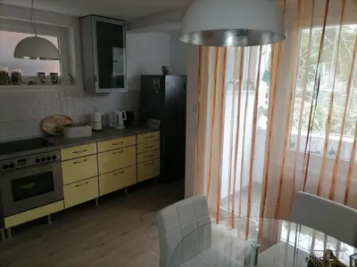 a kitchen with a table and chairs and a window at Apartman iza Boske in Banja Luka