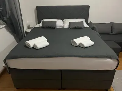 a bed with two towels on top of it at Studio apartman MyPLACE in Bihać