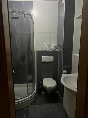 a bathroom with a shower and a toilet and a sink at Studio apartman MyPLACE in Bihać