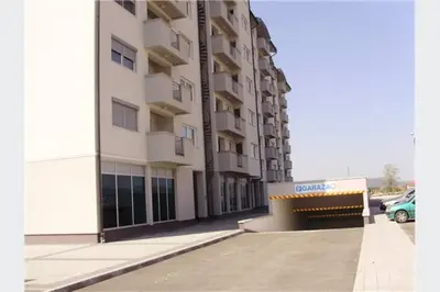 a large building with a car parked next to it at Studio apartman MyPLACE in Bihać