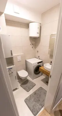 a small bathroom with a toilet and a sink at LuxDS in Tuzla