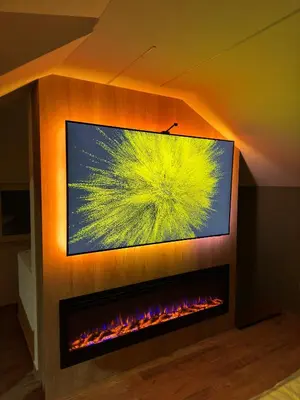 a living room with a tv and a fireplace at Apartman Dom in Vareš