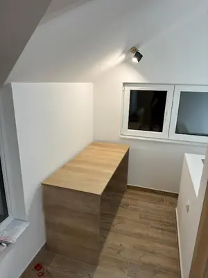 a small room with a wooden bench in the corner at Apartman Dom in Vareš