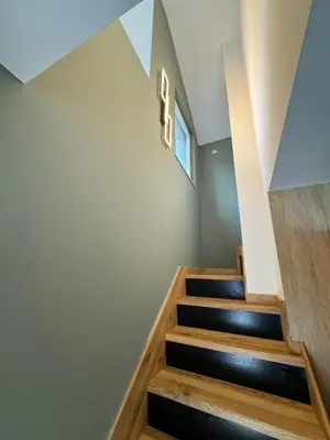 a staircase in a house with a number one sign on the wall at Apartman Dom in Vareš
