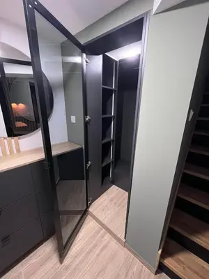a room with a staircase and a mirror at Apartman Dom in Vareš