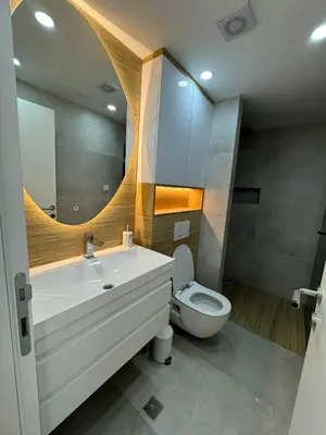 a bathroom with a sink and a toilet and a mirror at Apartman Dom in Vareš