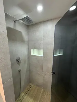 a shower with a glass door in a bathroom at Apartman Dom in Vareš