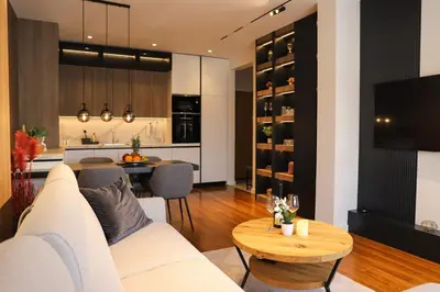 a living room with a white couch and a table at ModernApartmentsBL in Banja Luka