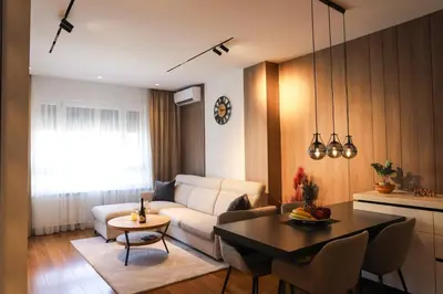 a living room with a couch and a table at ModernApartmentsBL in Banja Luka