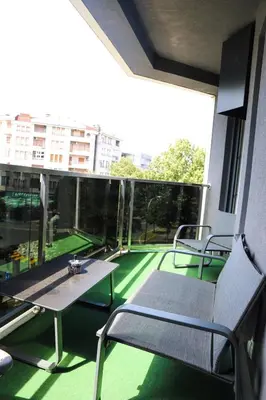 a balcony with a table and chairs on a building at ModernApartmentsBL in Banja Luka