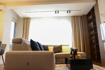 a living room with a couch and a window at ModernApartmentsBL in Banja Luka